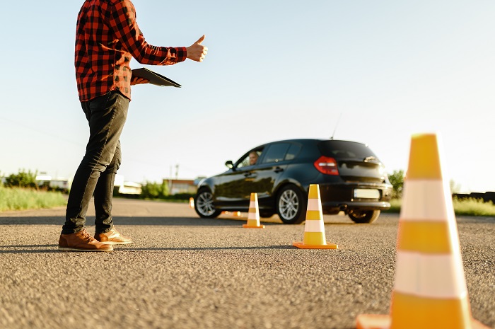 instructor helps female student drives cones lesson driving school - negligence in Clinical Negligence