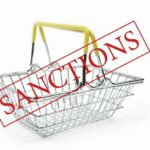 word sanctions empty iron shopping basket supermarket white background is isolated - Iran and Libya Sanctions in Business and Commercial Law