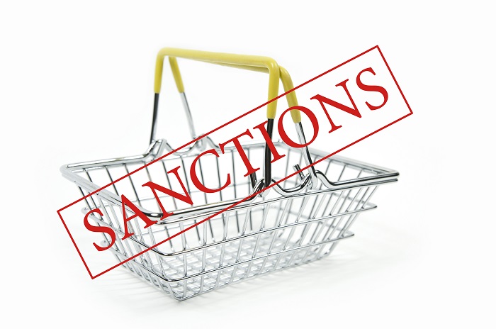 word sanctions empty iron shopping basket supermarket white background is isolated - Iran and Libya Sanctions in Commercial and Business Law