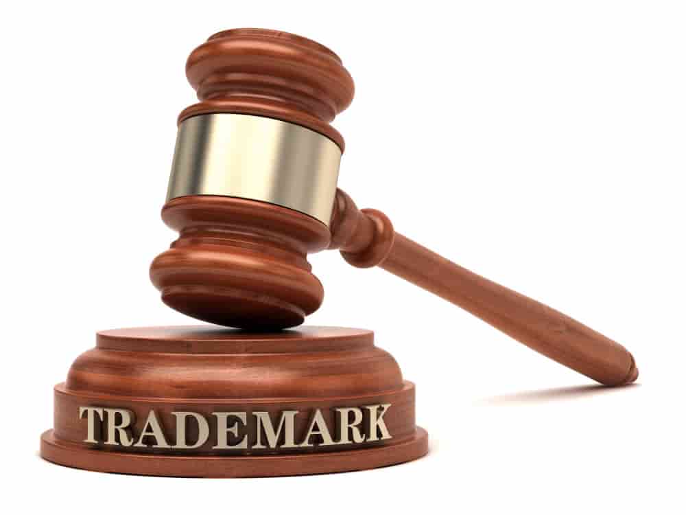A wooden hammer and stand at a court used to trademark a logo in the USA