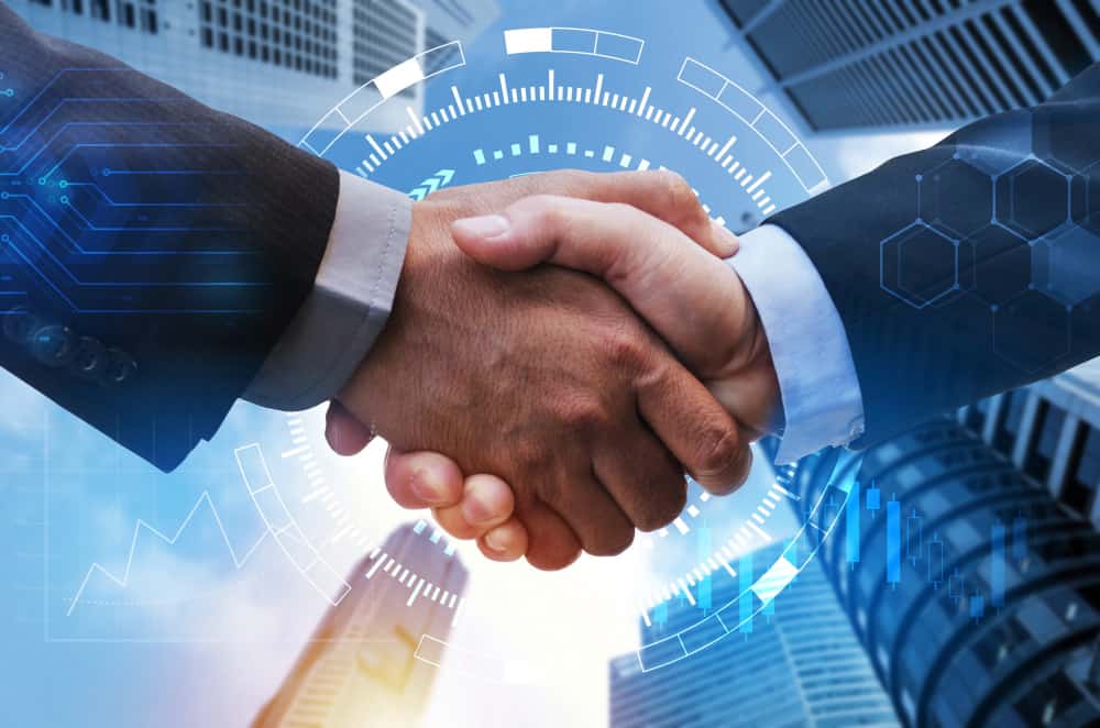 Two business partners handshake after signing International sales of goods contracts