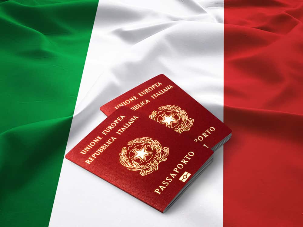 Two passports kept on Italian national flag