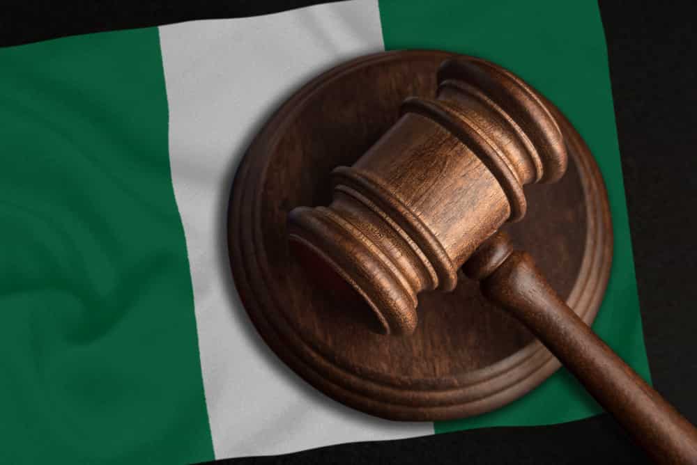 Nigerian flag, wooden hammer and Hisbah Is Illegal In Nigeria