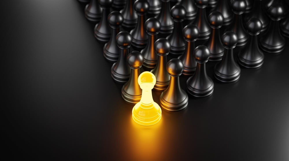 The golden chess piece shining among the black chess. 