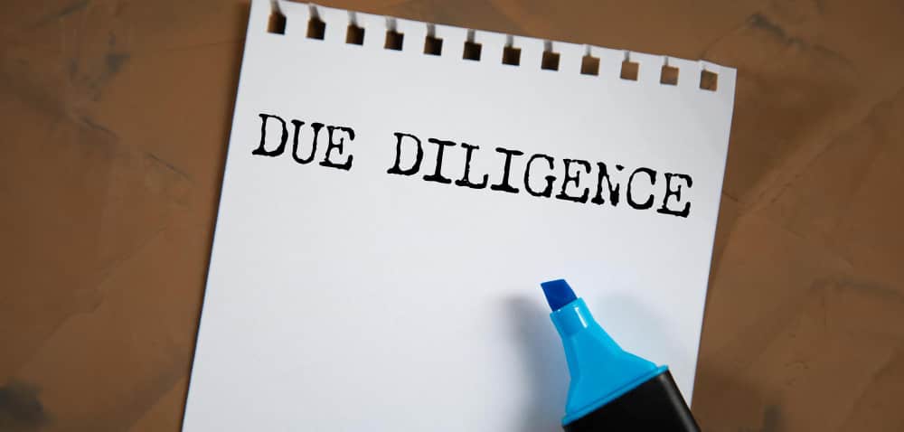 Due diligience written on a file paper as next step in compliance fundraising