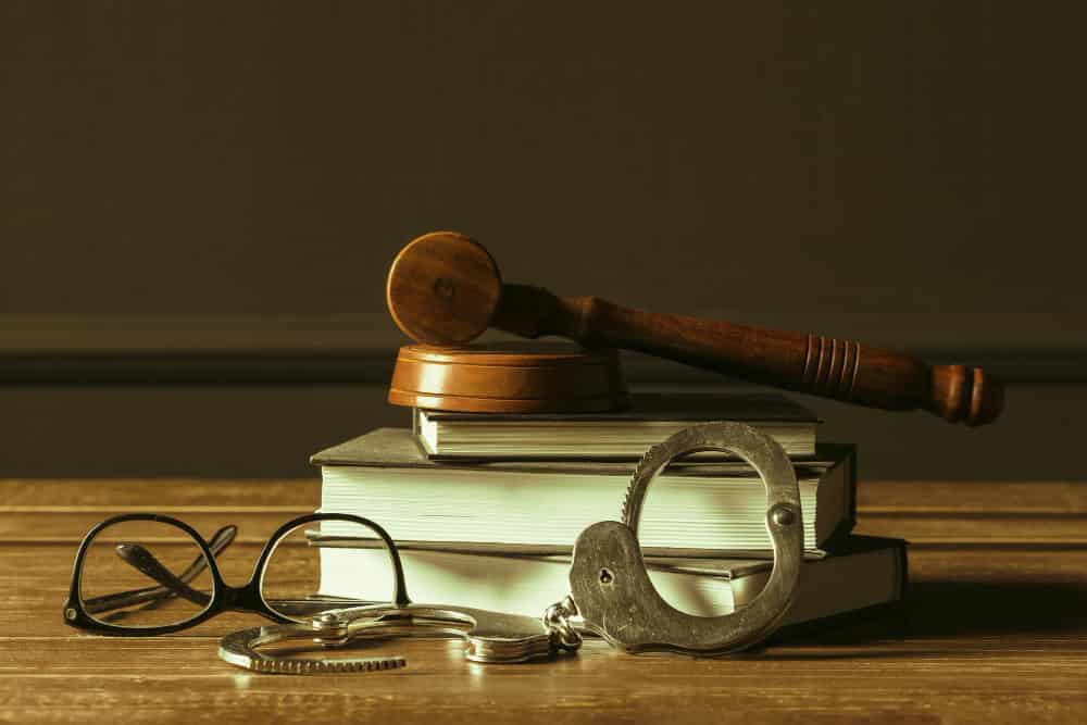 The wooden hammer, hand cuffs and books represent suing foreign corporations