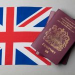 A immigrant passport placed over UK flag to immigrate from Brazil to the UK