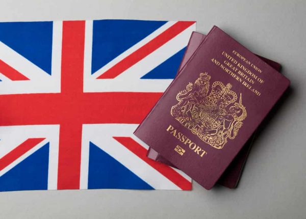 A immigrant passport placed over UK flag to immigrate from Brazil to the UK