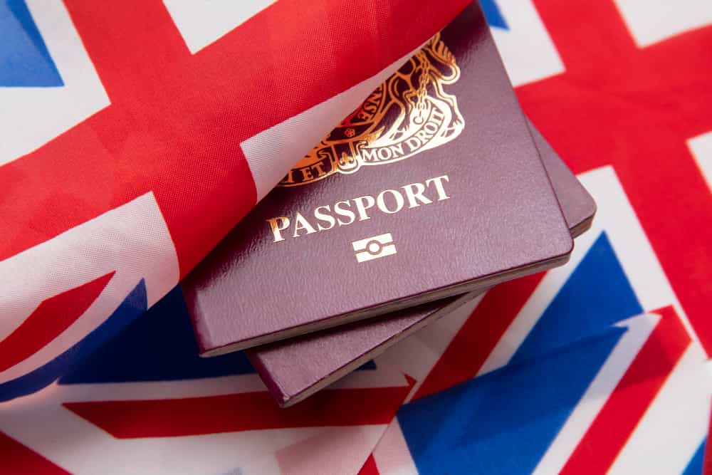 Two passports wrapped in UK flag