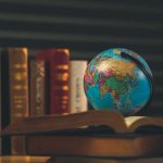 A picture of the globe and a law book on how to work abroad as an Indian lawyer