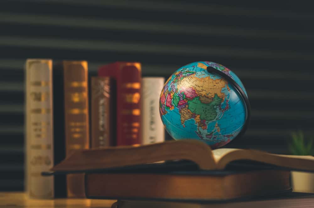 A picture of the globe and a law book on how to work abroad as an Indian lawyer