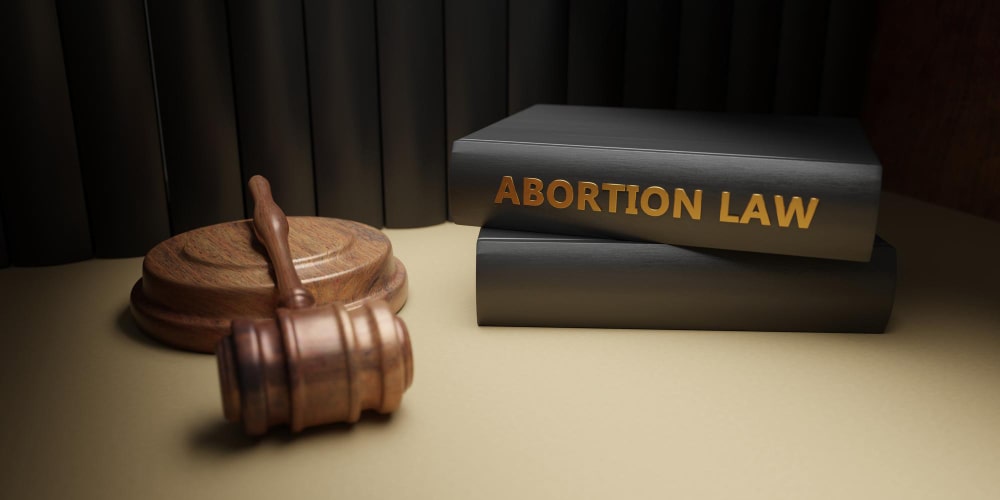 A wooden hammer with abortion law books