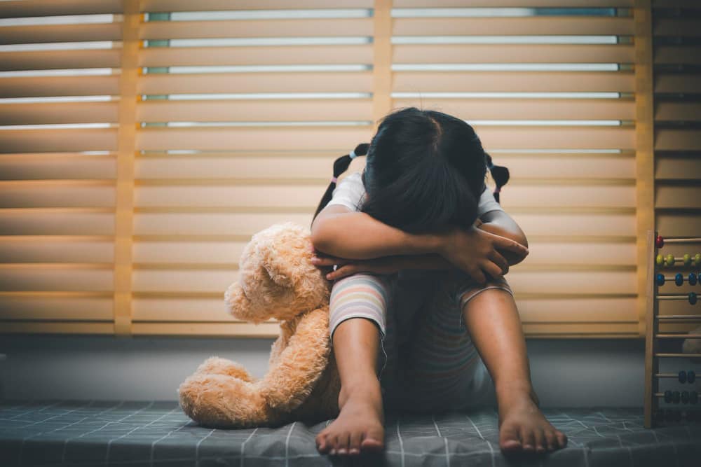 A sad child with her teddy bear in UAE