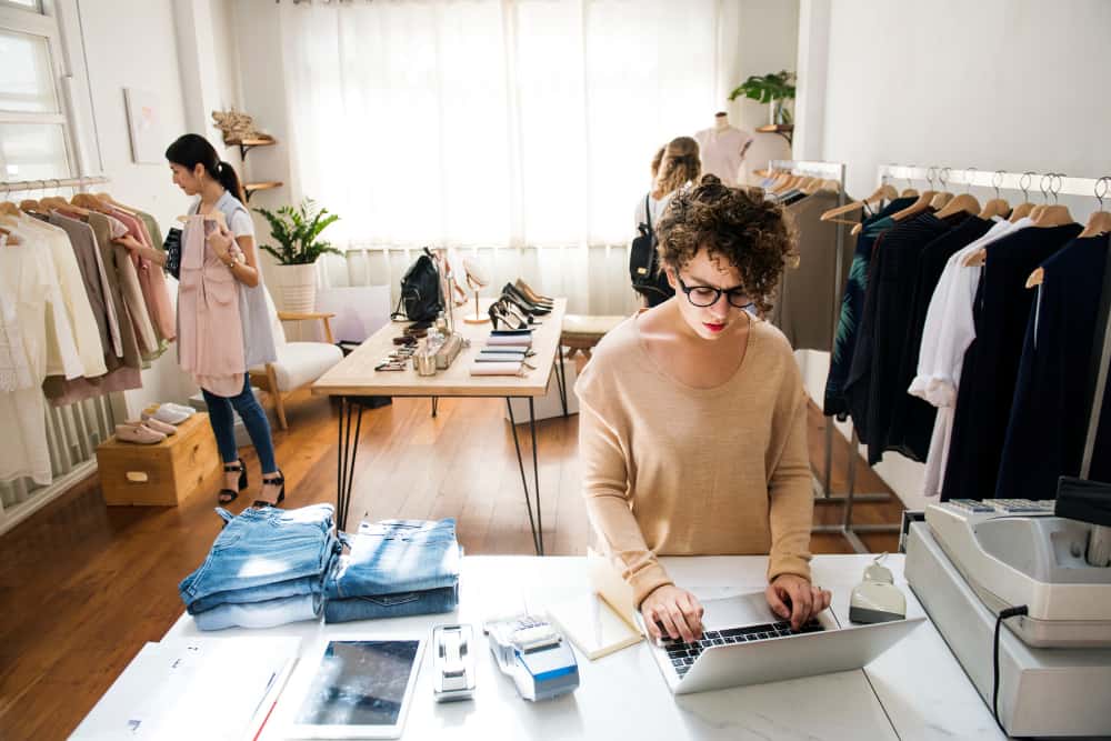 female business owner is using laptop min - Fashion Licensing in Commercial and Business Law