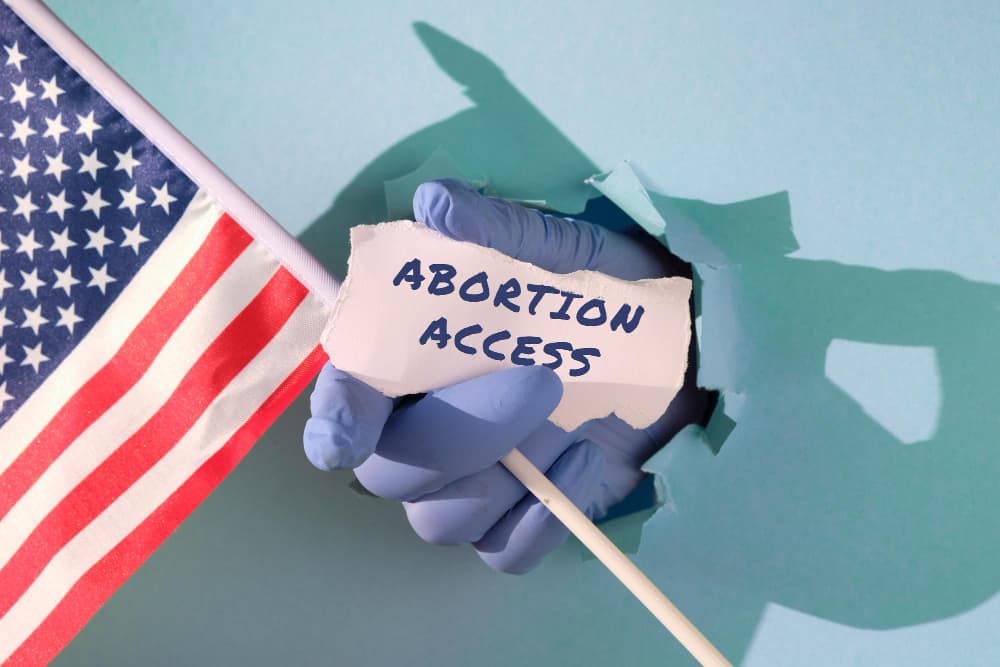 text abortion access scrap paper medics doctors hand glove holding usa american flag scrap paper min - Abortion be Illegal in the US in Abortion