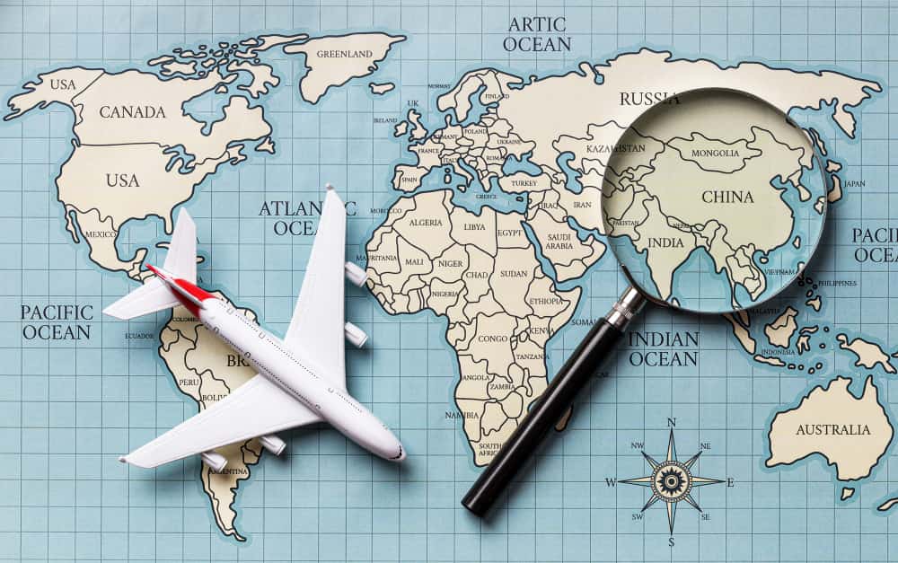 A plane, magnifier and a world map in a immigration agency