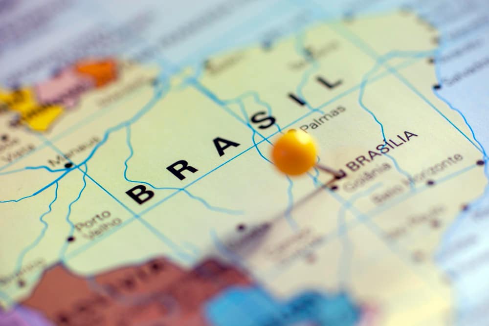 A world map where a pin has been kept on brazil