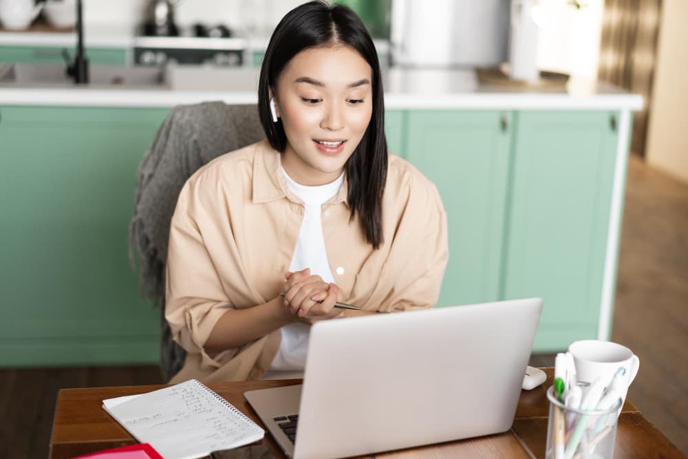 young corporate woman working from home asian girl has online classes remotely talking video chat min - Working Remote Tax Implications in the USA in General