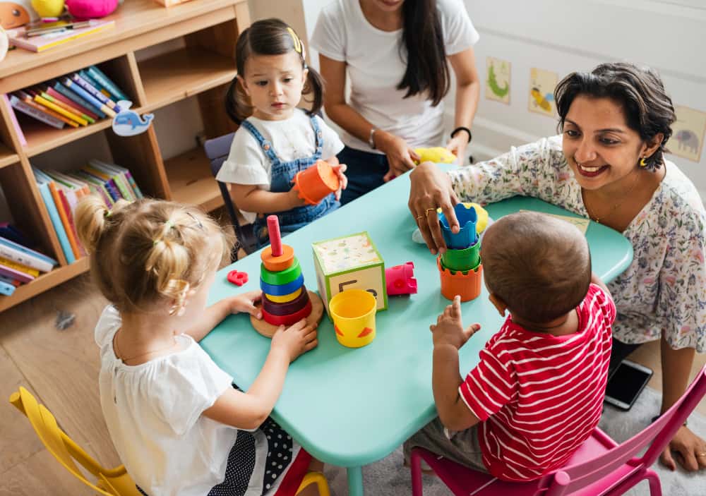 A Child Care Licensing officer in a child care playing with children