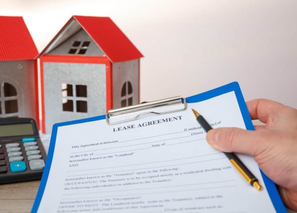A lawyer finalizing the Lease vs Rent for a house owner