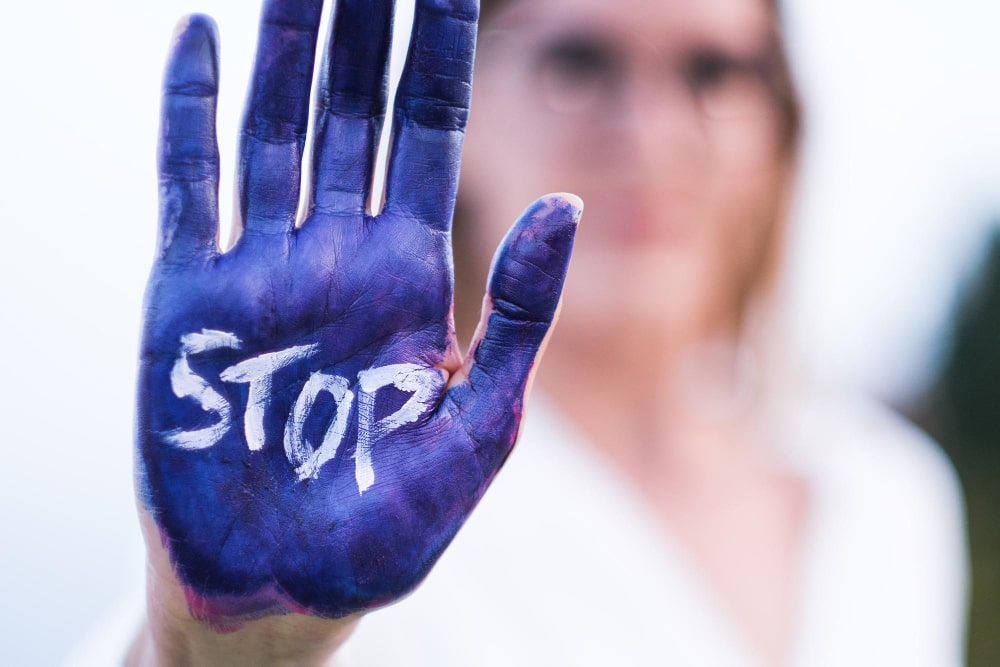 A Woman painted her hand in blue and wrote stop in a rally on Human Trafficking Laws in the US