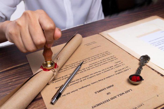 A lawyer stamping the separate Wills for each country made for a old client