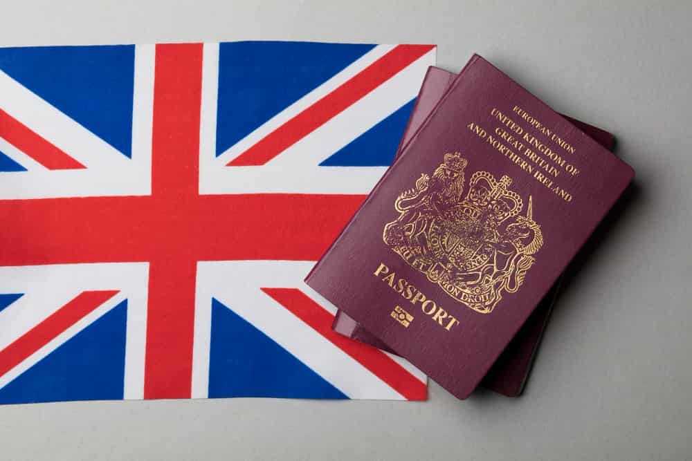 A immigrant passport placed over UK flag to immigrate from Brazil to the UK