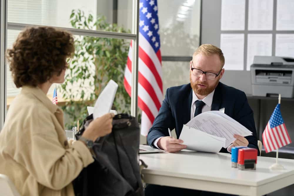 A woman discussing the Legal dispute over investment visa with an immigration lawyer